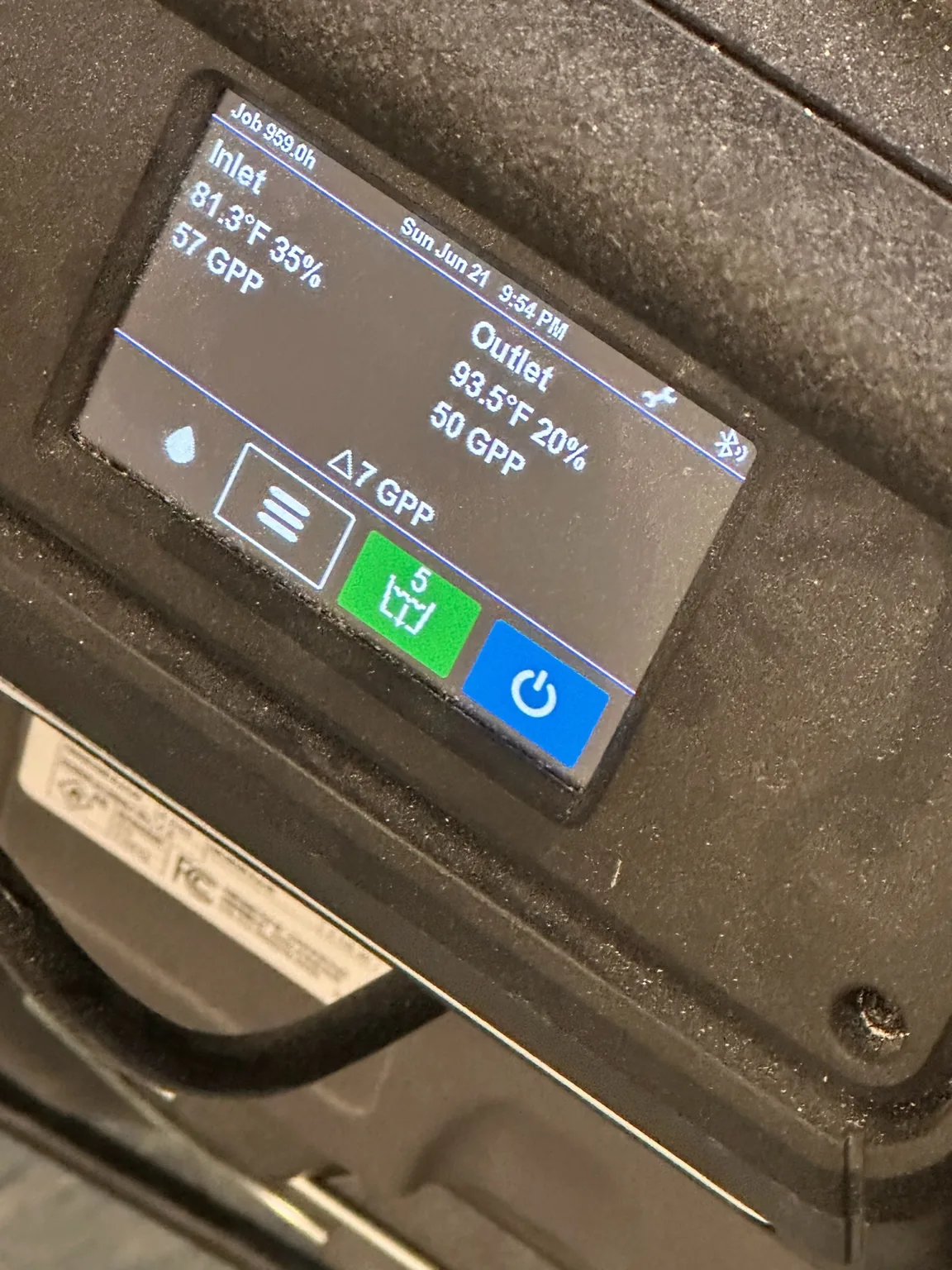 Dehumidifier inlet and outlet psychrometric conditions displayed at the equipment.