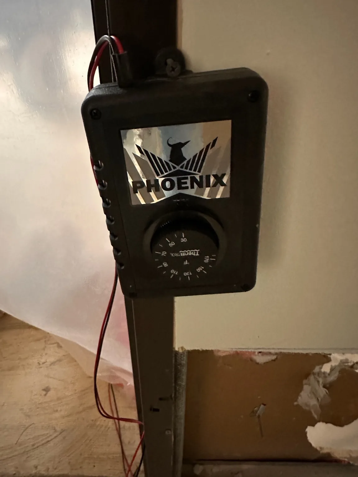 Specialty drying equipment/control documented adjacent to an opened wall assembly.