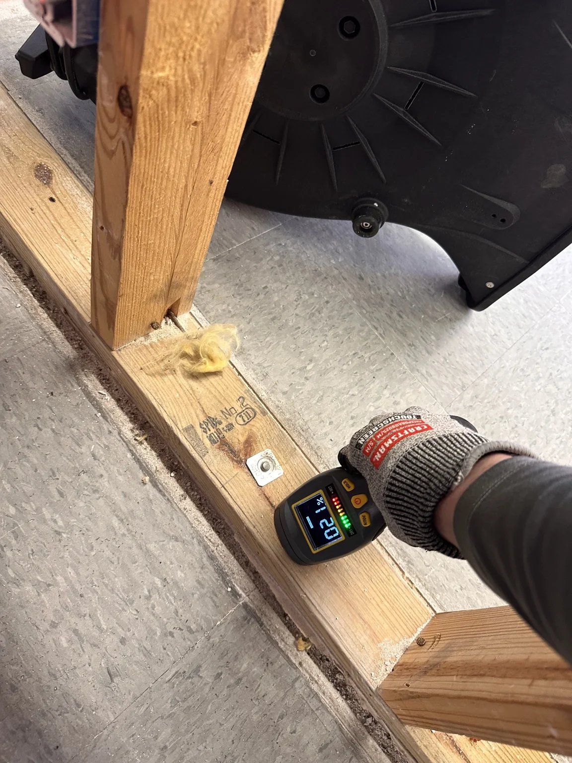 Moisture meter reading taken directly at exposed wood framing