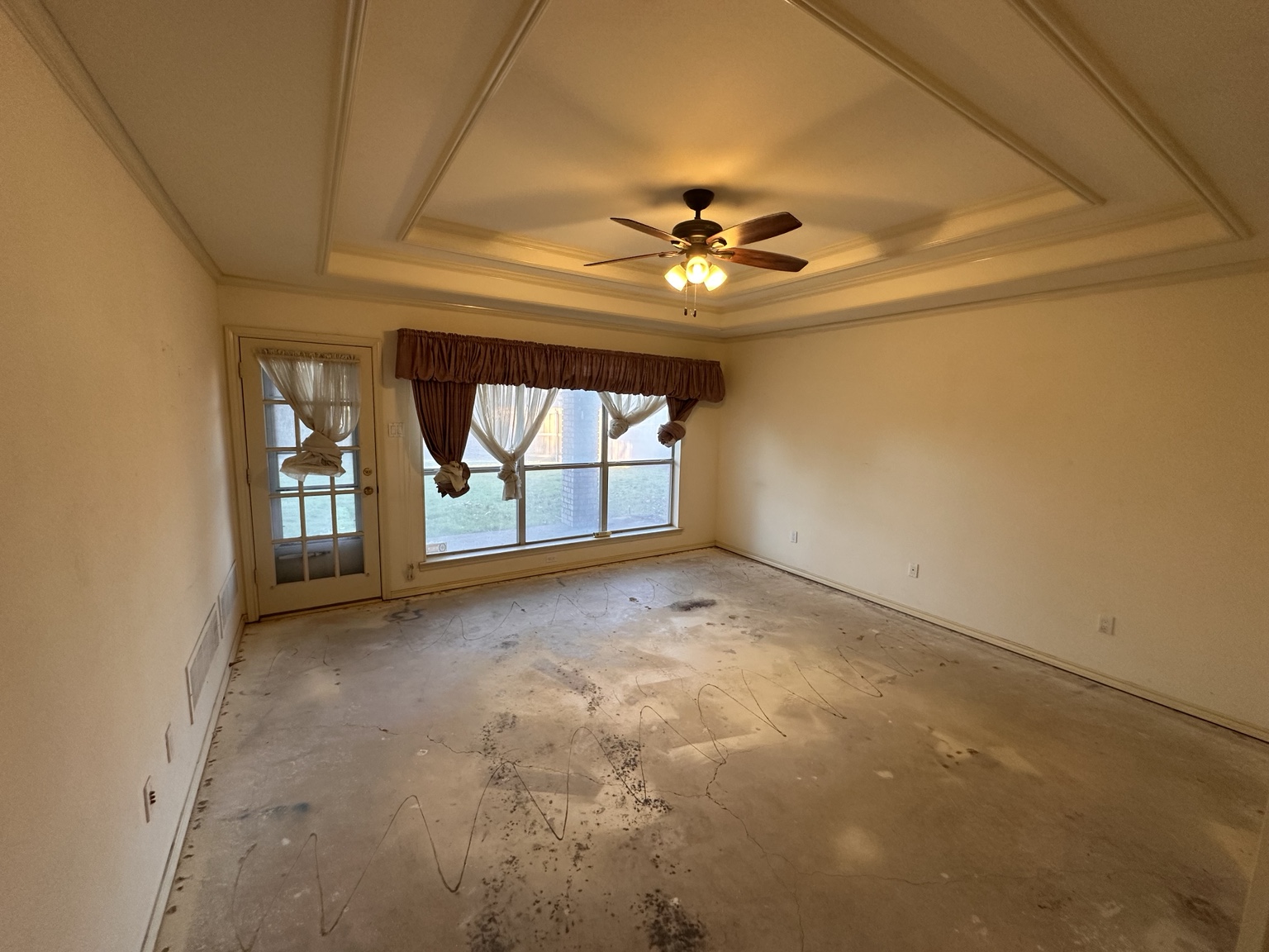 Exposed slab in bedroom after carpet removal.
