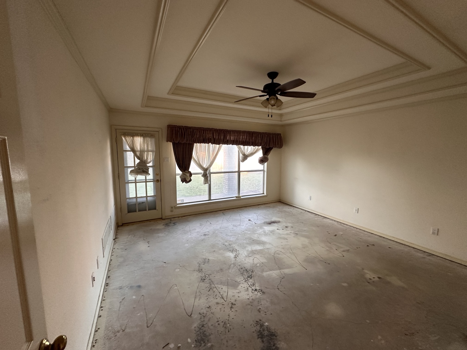 Exposed slab during pet odor source-removal work in a Plano home.