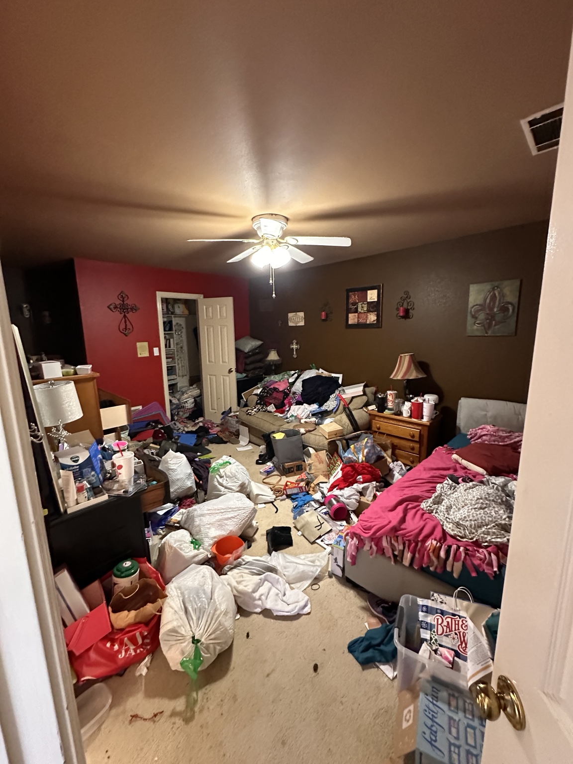 Cluttered bedroom with visible contamination and heavy carpet impact.