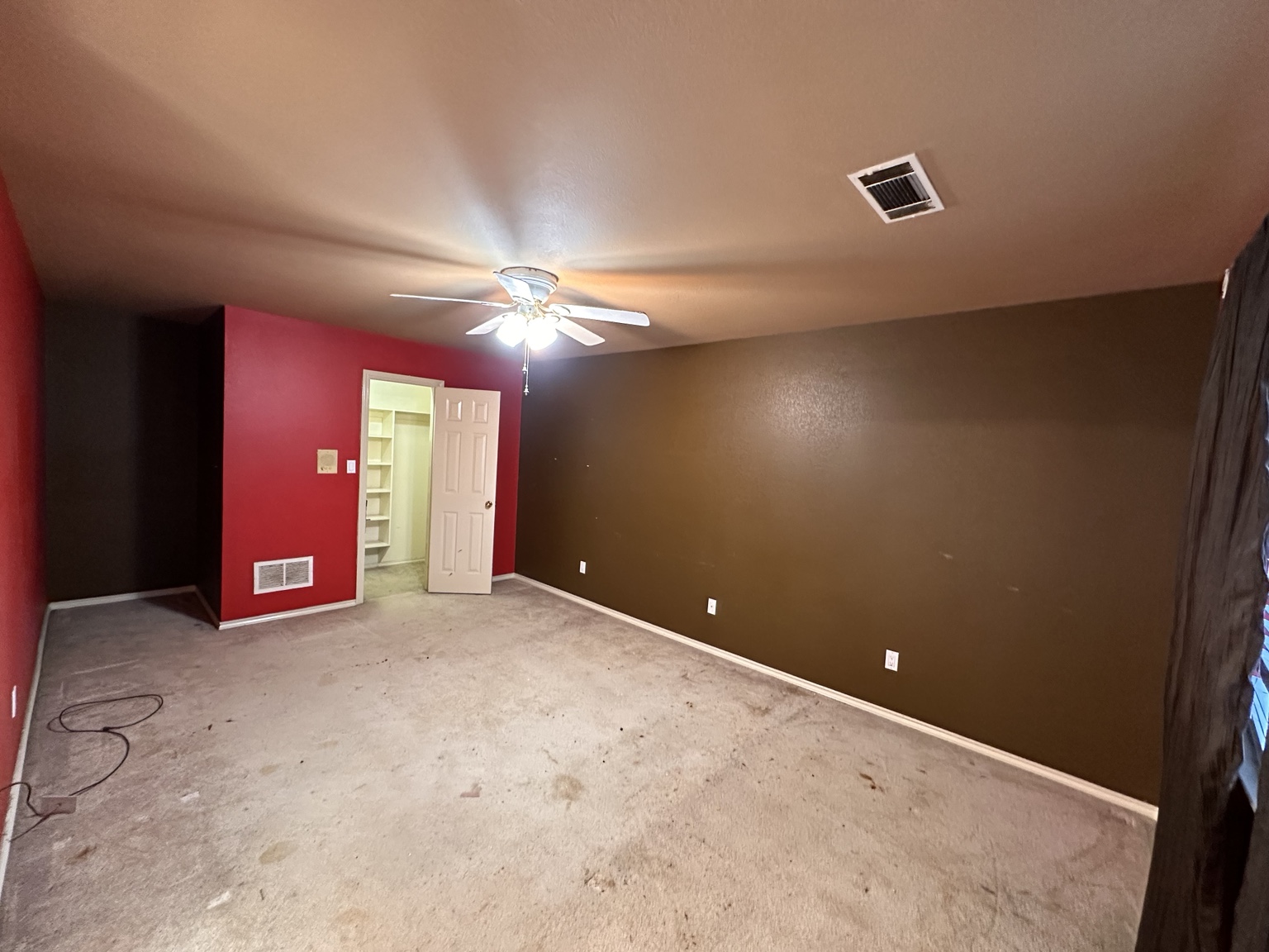 Bedroom after cleanout showing accessible carpeted floor.